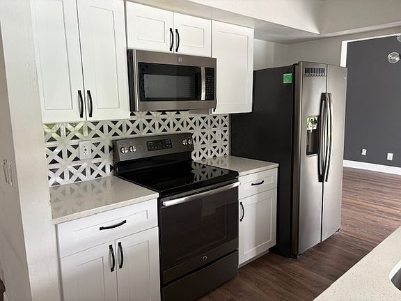 Newly updated kitchen with stainless appliances and designer tile backsplash.