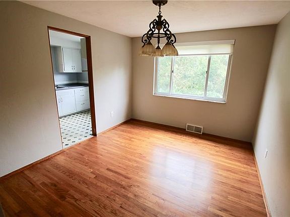Dining room with hardwood floors and a beautiful chandelier.