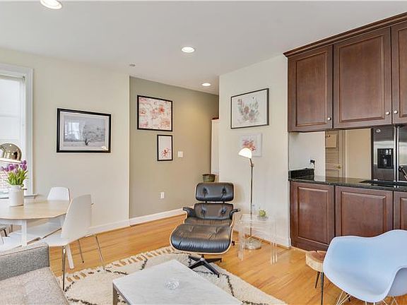 Recessed lighting and hardwood floors in living area.
