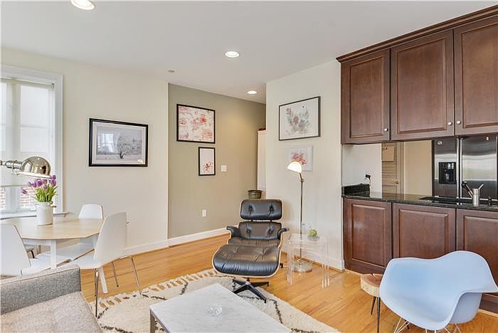 Recessed lighting and hardwood floors in living area.