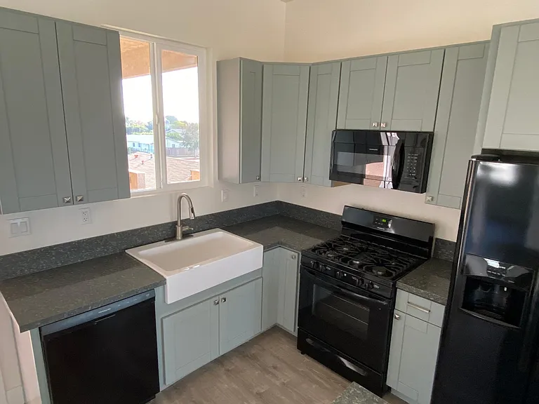 Apron sink, dishwasher, garbage disposal, gas stove, refrigerator with ice and water in the door