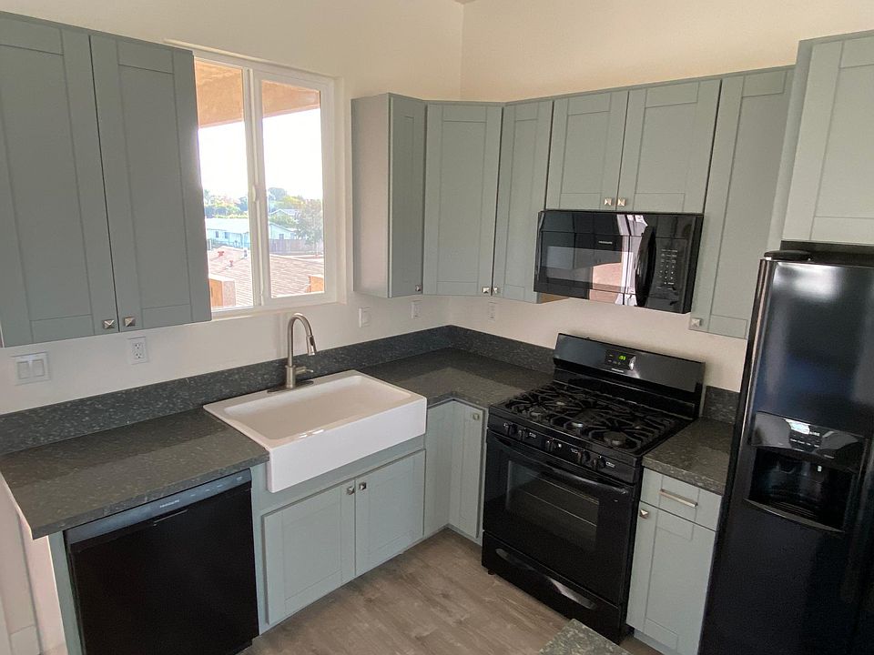 Apron sink, dishwasher, garbage disposal, gas stove, refrigerator with ice and water in the door