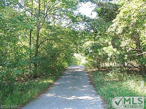 Follow the paved drive into your own private paradise.  Your stress will release as you wind your way through the trees to your home nestled in the trees away from it all!