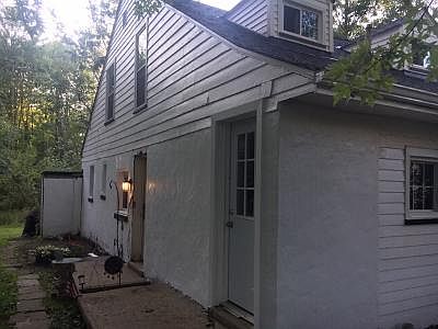 Entry is through the door next to the light. This is only the first floor apartment. Apartment faces a wooded area with lots of wildlife!