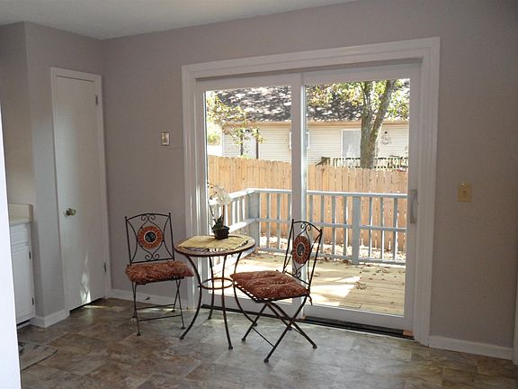View from kitchen out towards the deck and fenced back yard area. Note that the patio door is also new