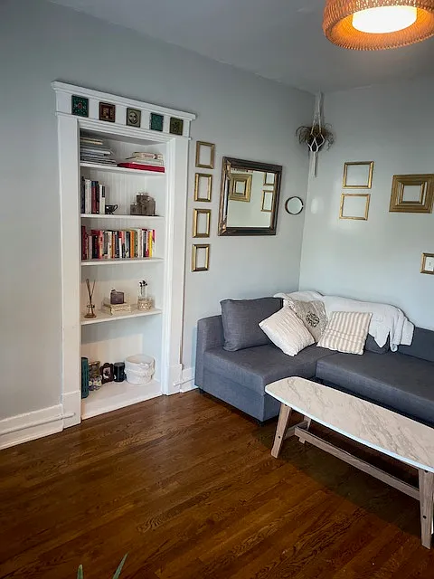Built-in bookshelf/storage in the living room. - 2120 Belmont Blvd #C2