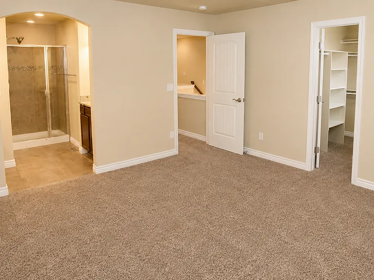 Primary suite with walk-in shower, walk-in closet with built-in shelving, and a private en suite bath.