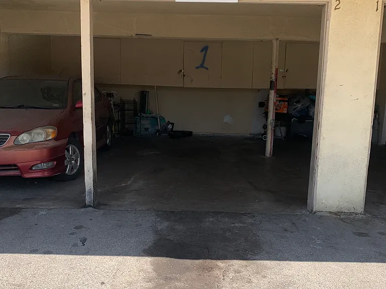 House is assigned this middle carport space and cabinet.