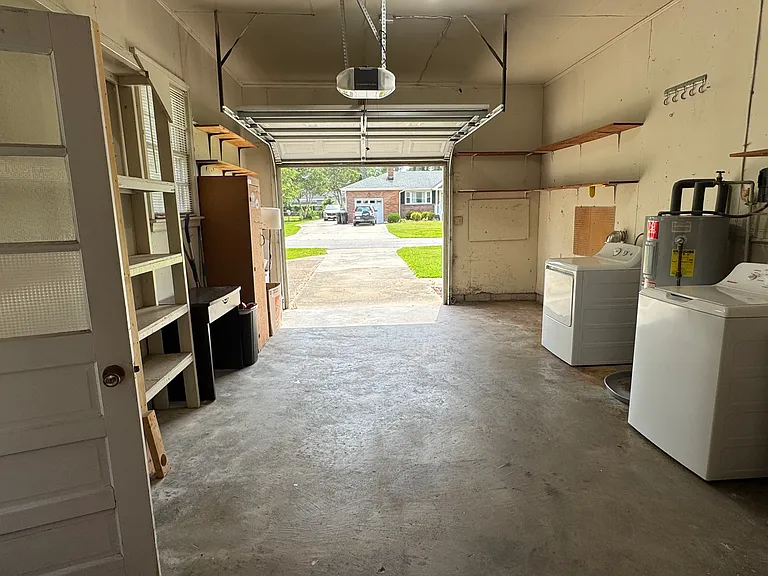 Garage with washer, dryer and laundry sink. Washer and dryer are as-is or tenant may provide their own if preferred. Washer is one year old.