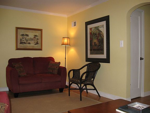 Living room with hardwood, trim, and crown molding