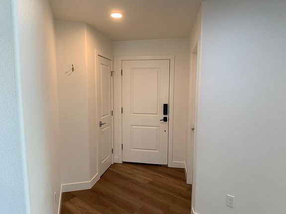 Entry with 2 closets with shelves and clothing bar