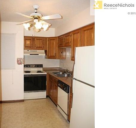Spacious kitchen offers electric range, dishwasher and refrigera