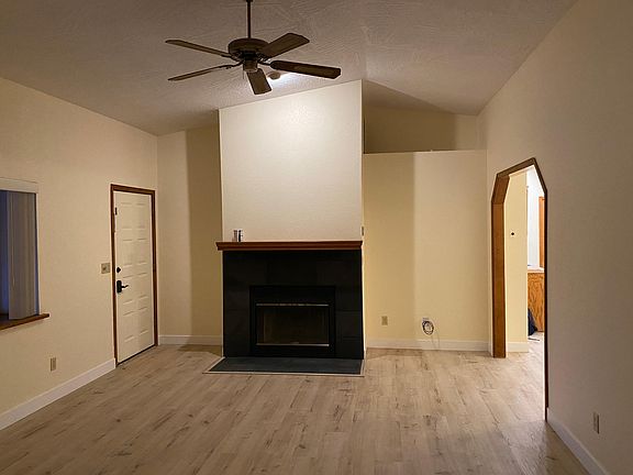 Living Room, vaulted ceiling, with house door entrance to the left and dining area entrance to the right