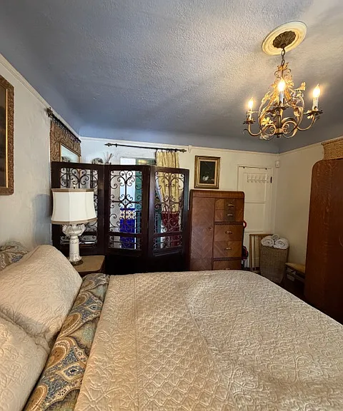 View from Window wall across Bedroom to Vanity area and Shower/Toilet beyond