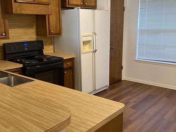 Kitchen w d/w, elec stove, 25 cu ft fridge w ice & water dispenser, pantry. Vinyl flooring throughout the home.