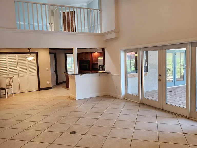 Beautiful vaulted Den with view of loft