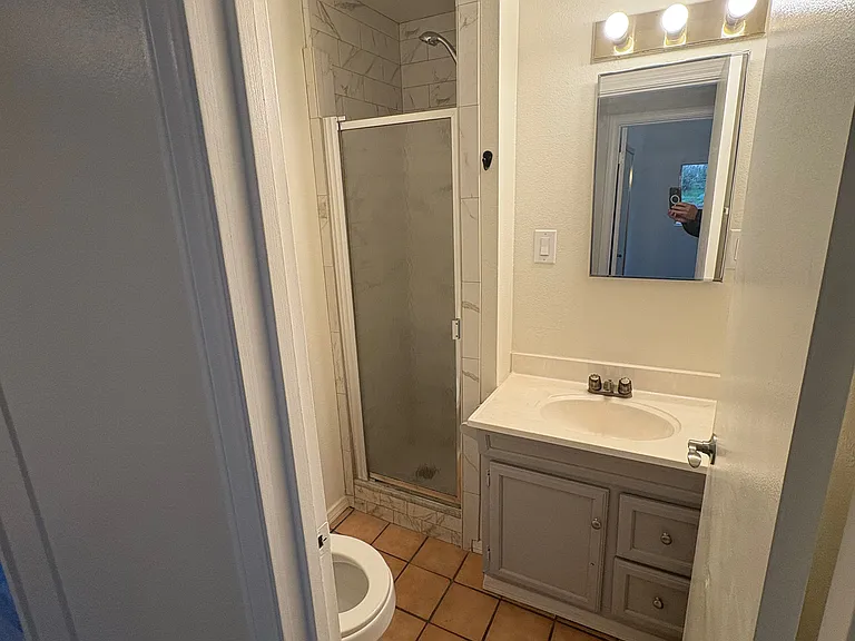Across the hall, bathroom with toilet, sink and shower