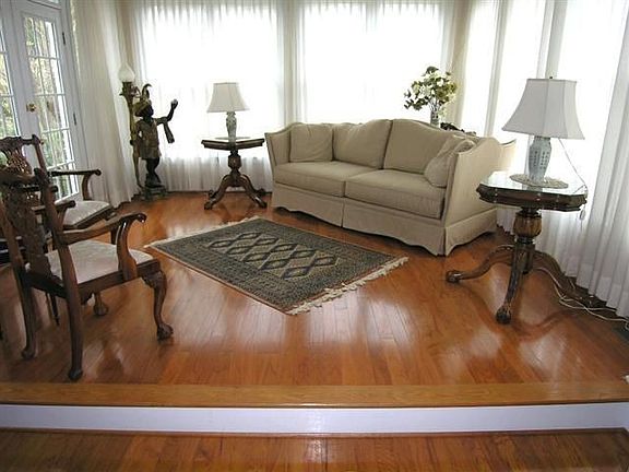 Cheery sunroom has french doors leading out to the fenced backyard & pool.