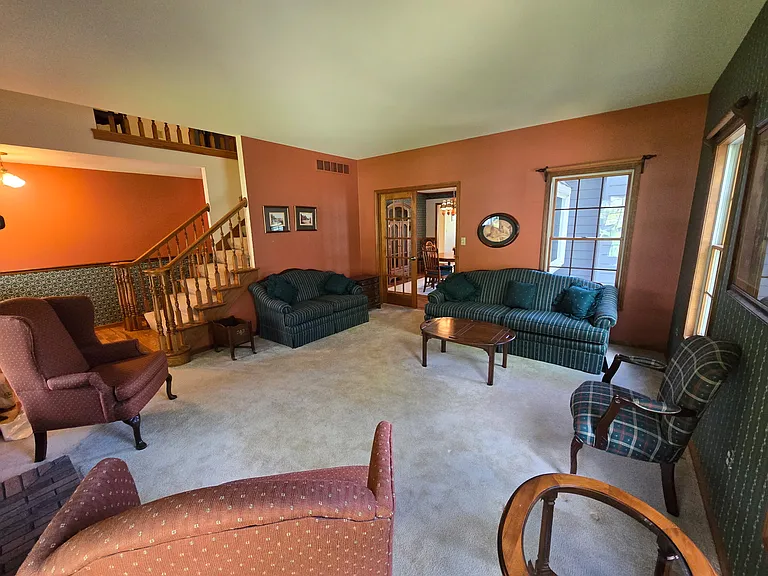 First floor living room and entry way leading into dining room