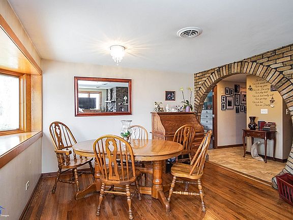 On the other side of the living room is the first of three dining spaces.  The table is situated in front of a bay window.  Lots