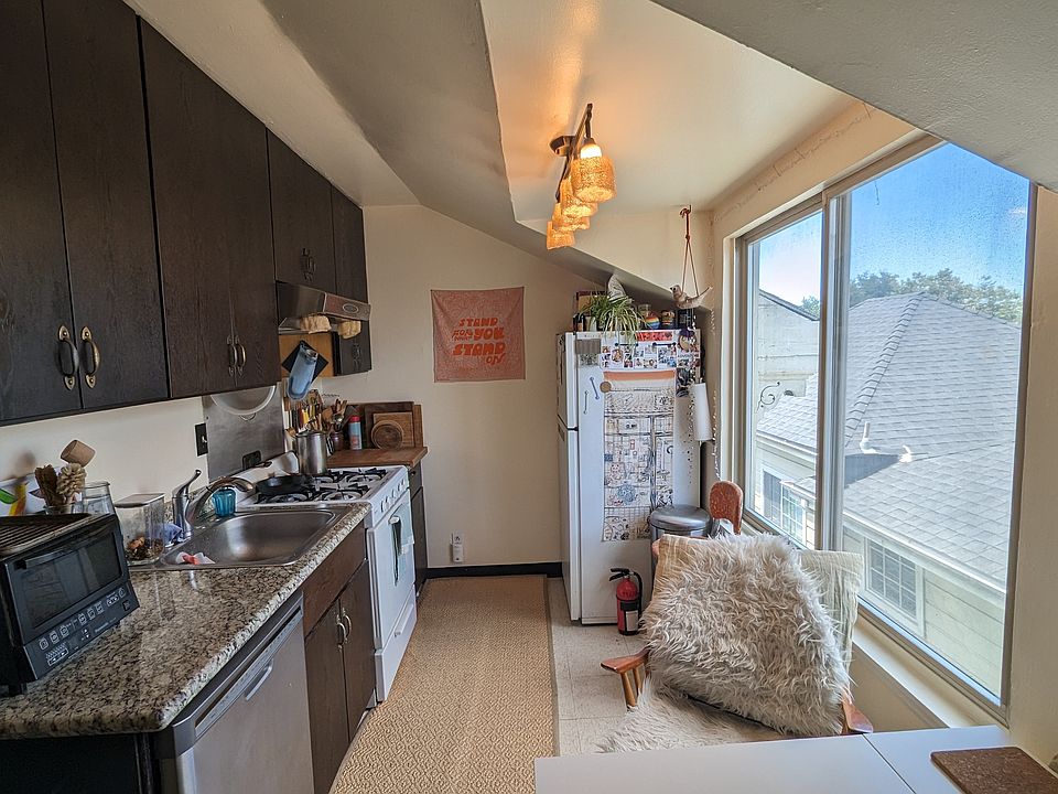 kitchen with rooftop view, dishwasher, gas stove and fridge