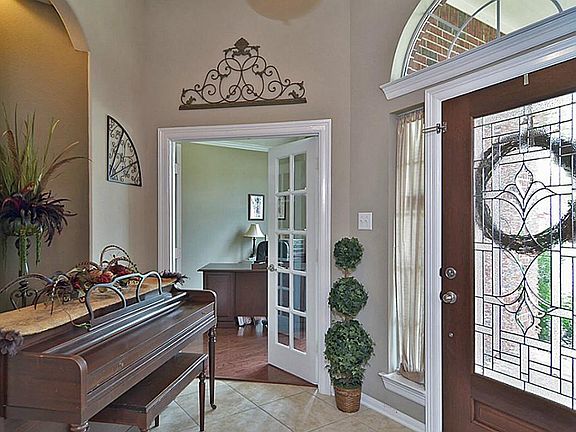 The tiled entry is flanked by the study and dining room- both with beautiful wood flooring.
