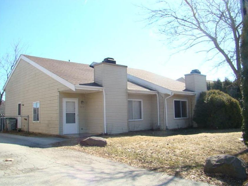 Front of home with front yard and partial view of shared driveway