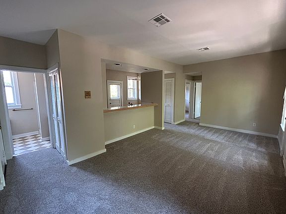 Living room, kitchen bar, front bathroom on left.