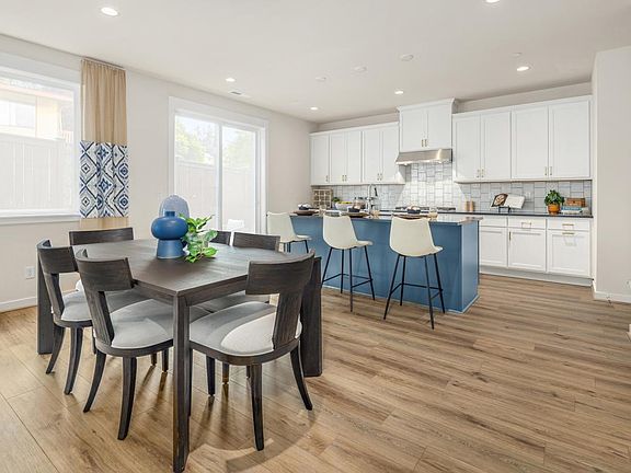 White shaker cabinets complemented by a blue island