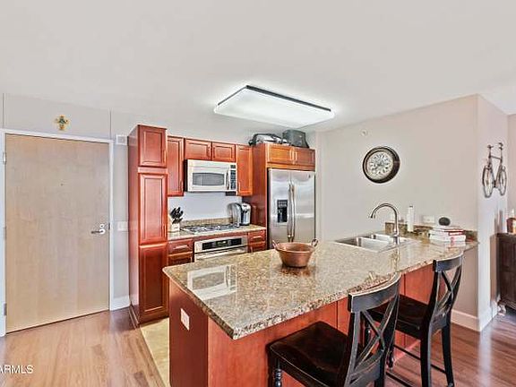 Eat in Kitchen with cherry wood cabinets, granite counter tops, travertine, stainless steel appliances and gas Range.