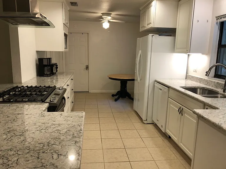 Newly remodeled kitchen, 9'7" x 18'. Has 5 burner gas stove, dishwasher, microwave, breakfast nook, and beautiful quartz countertops.