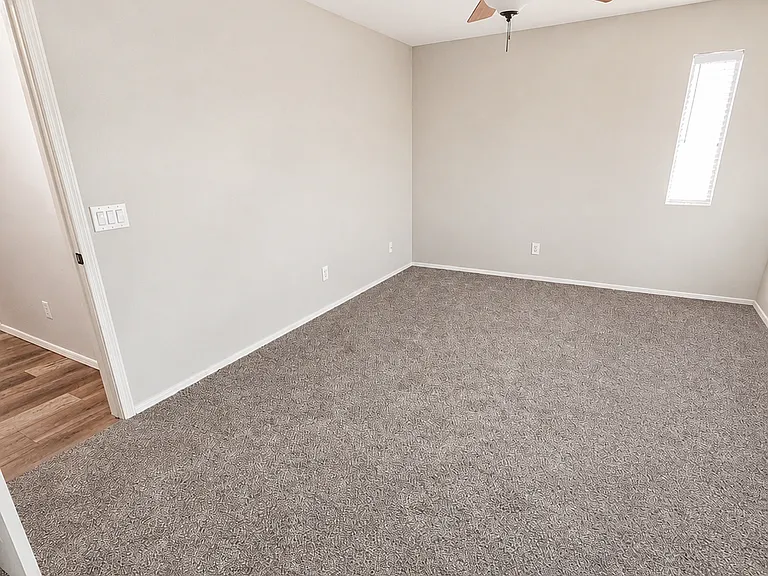 Large 2nd bedroom with window, closet, fan and new carpet