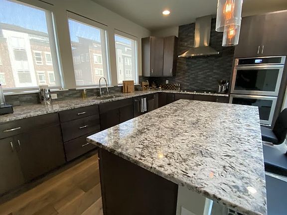 Double ovens, microwave, massive Jenn-Air refrigerator, chef's knives, Caphalon cookware.