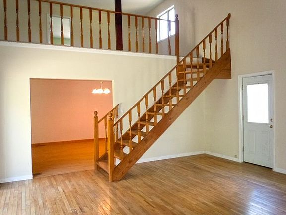 Great 2-Story Family Room with Beautiful Hardwood Floors and Lovely Stair Case