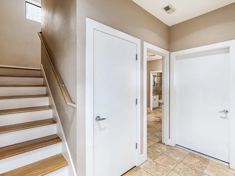 Entryway leading to first-floor bedroom and 2-car garage