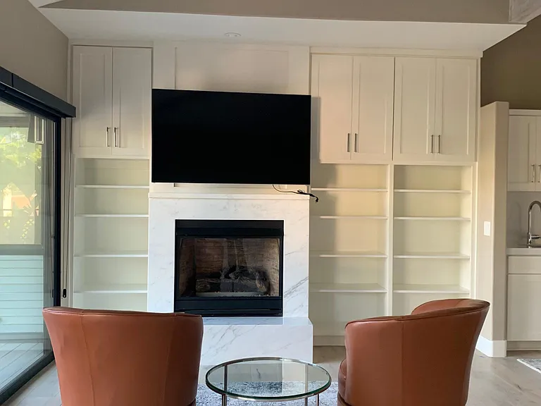 Marble surrounded gas fireplace with large flatscreen TV. Extensive cable package included.
