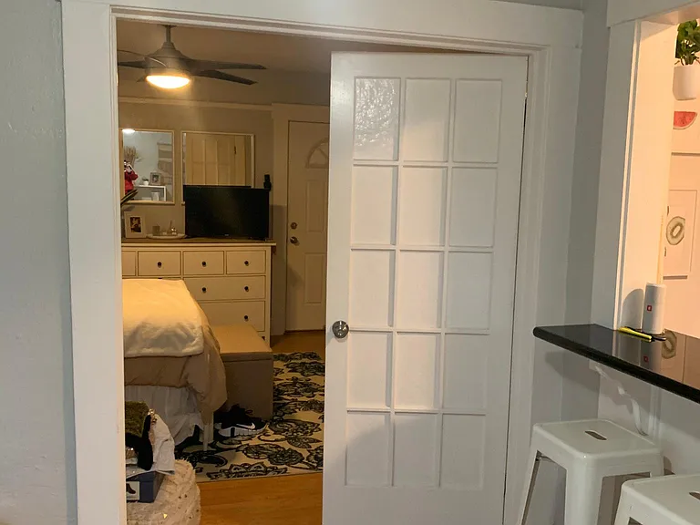Double French doors separate the living and sleeping area