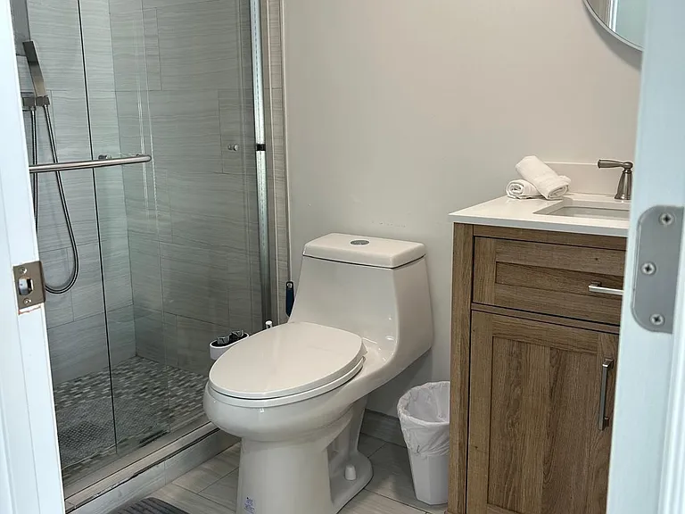 Bathroom with toilet, cabinet for storage, and basic essentials.