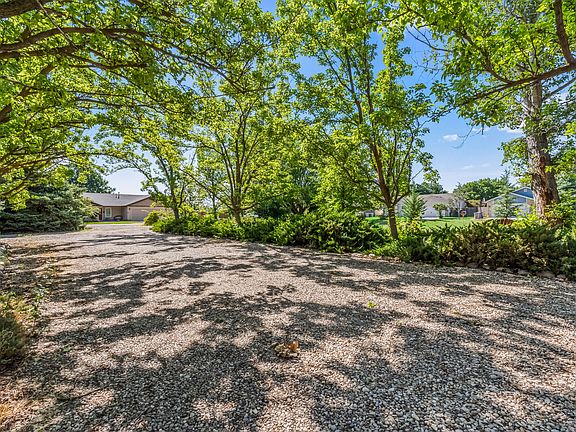 Back of House. Covered and shaded parking. Park-like setting.