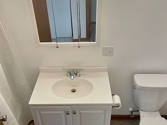 Bathroom with tub/shower combo and large storage closet.