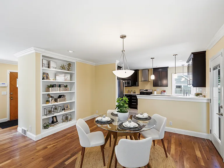 Dining area with kitchen in background, taken from the living area
