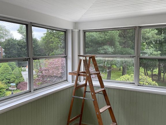 Sunny three-season room overlooking the garden and backyard