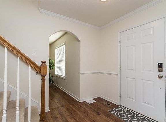 Foyer w/archway entry to family room.