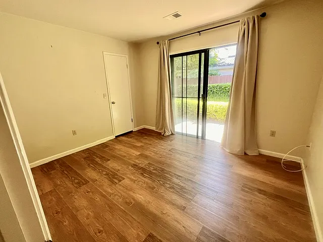 2nd bedroom with slider opening onto patio, walk in closet