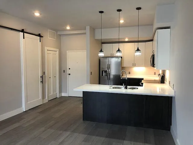 View of kitchen and entry from living space