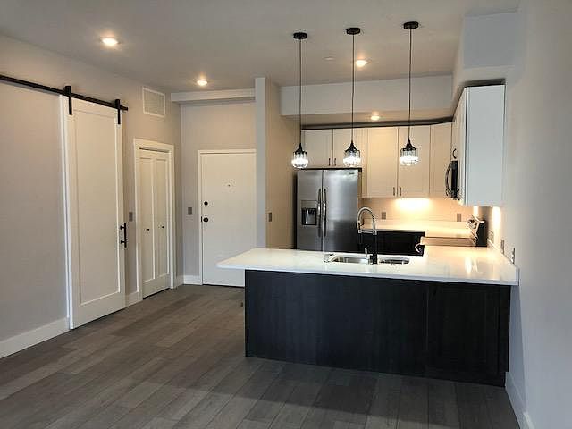View of kitchen and entry from living space