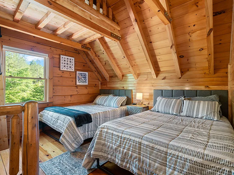 Upstairs bedroom with two queen beds and a loft space that includes a twin bed.