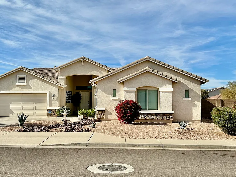 Discover your dream home in Litchfield Park A, featuring over 2500 square feet of elegance with vaulted ceilings and an open floor plan. Enjoy luxurious finishes, including brand new wood floors, granite countertops, and a relaxing backyard oasis