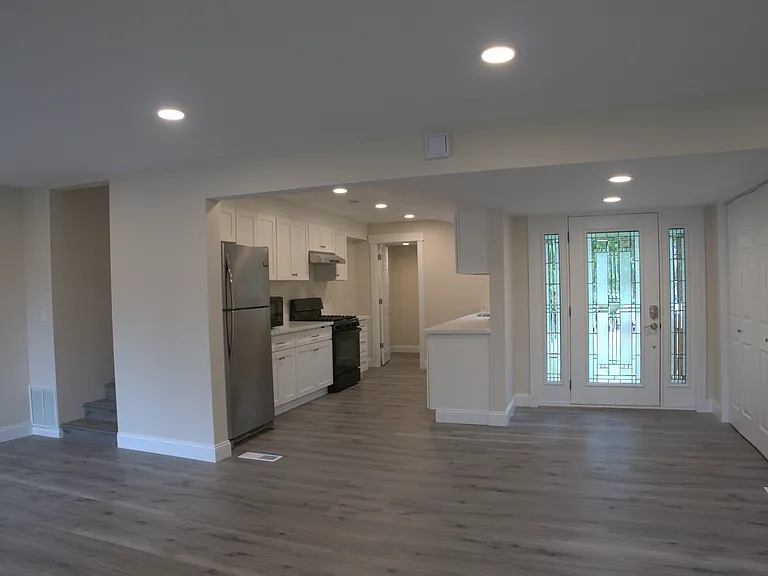 View of kitchen and entrance from living room.