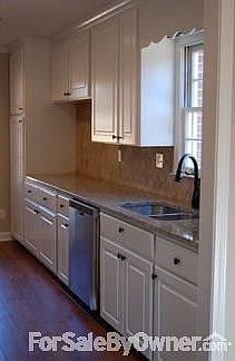 Beautifully remodeled galley kitchen
						:
						New appliances, granite and a tile backsplash complete this gorgeous kitchen.